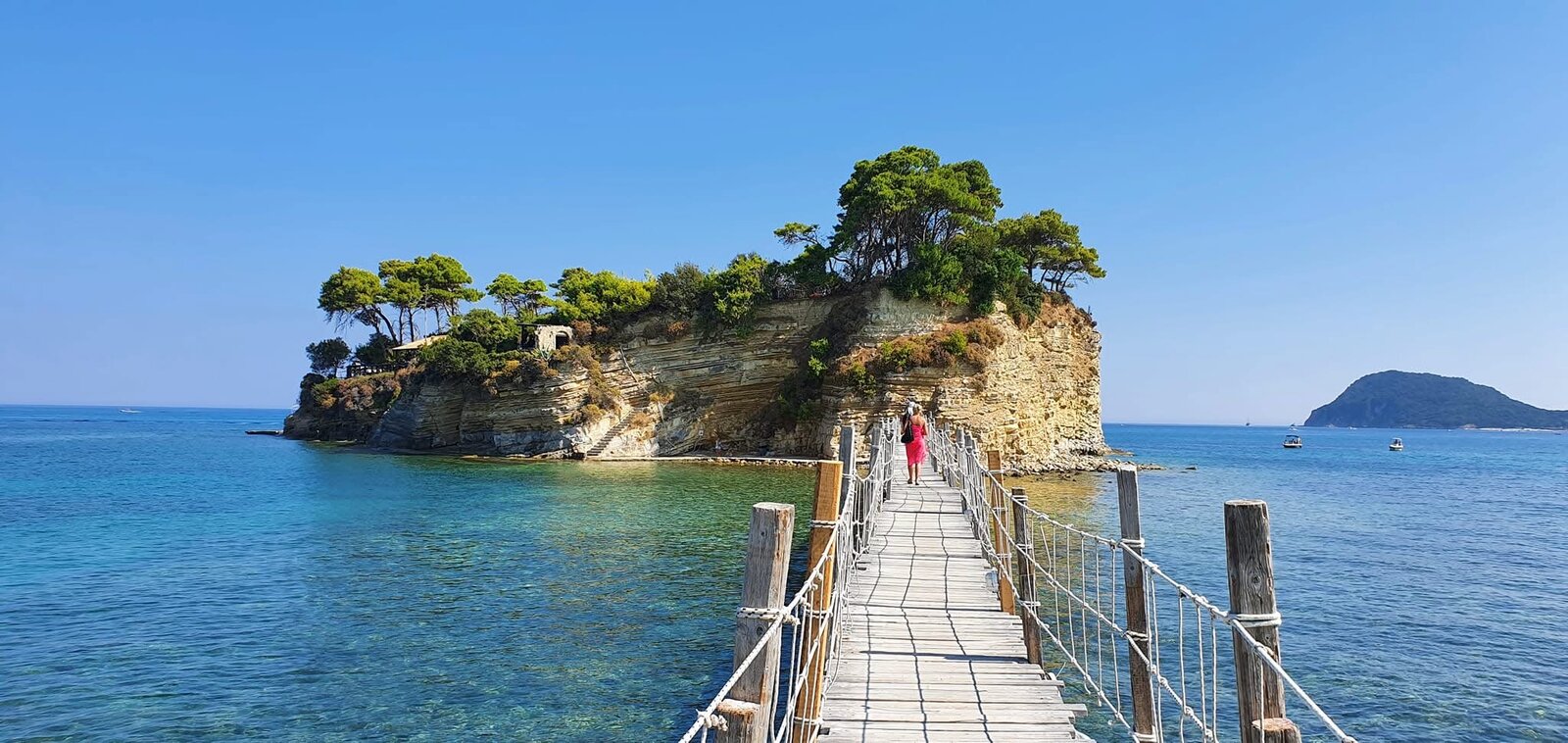 Wide-angle view of the Cameo Island cove with hanging white fabric and a distant island