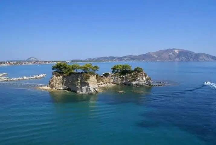Aerial overview of Cameo Island in the calm blue waters of Laganas Bay