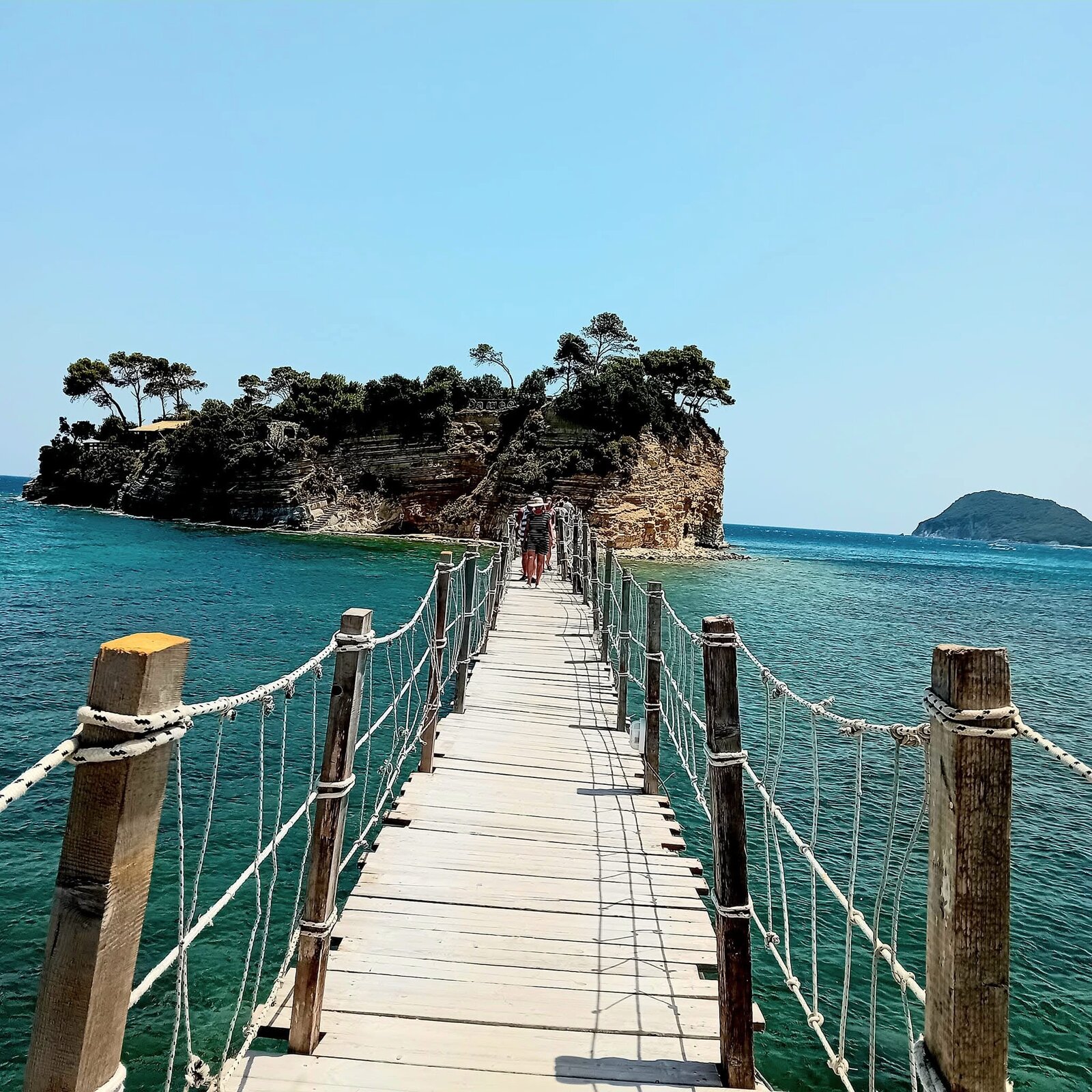 Top-down aerial of the Cameo Island cove with the cliffside bar and reed umbrellas