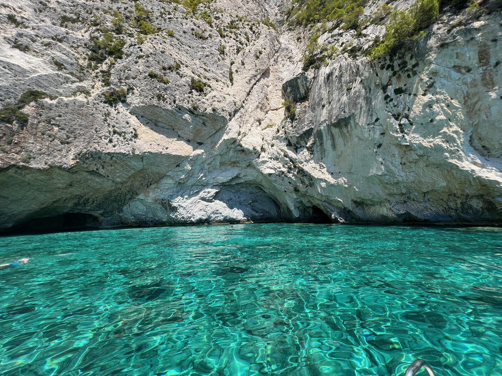 Close-up of the textured white cliff face above crystal turquoise water