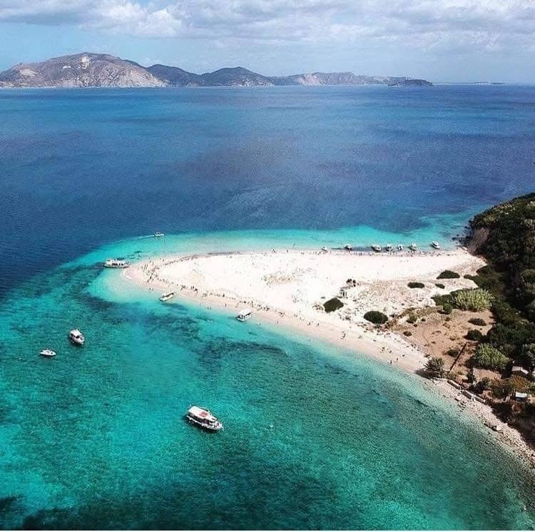 Aerial view of Marathonisi beach with boats and Zakynthos mainland in the background