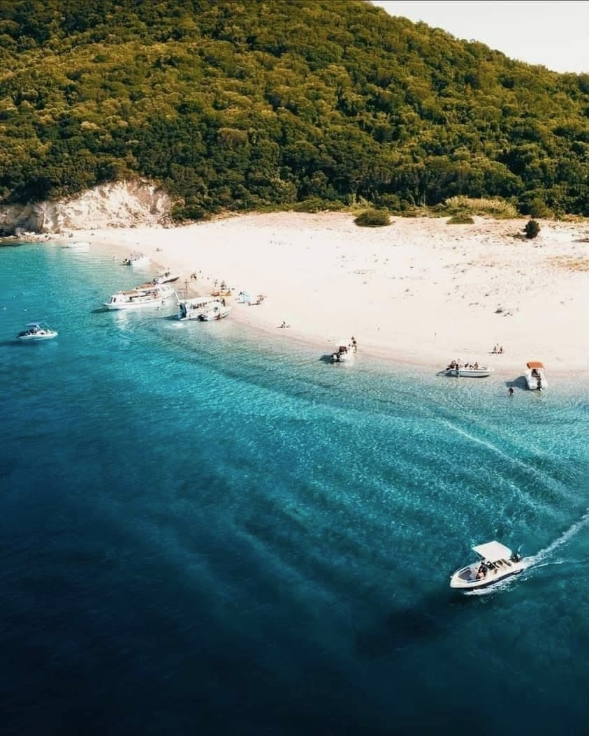Boats approaching the sandy shore of Marathonisi from above