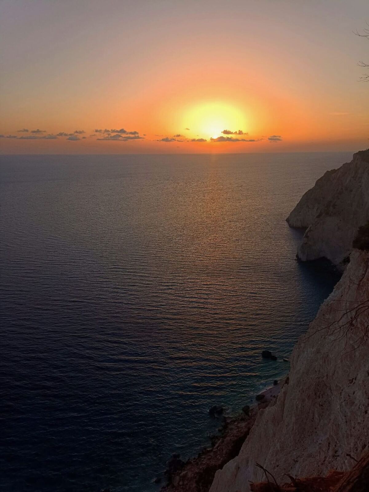 Golden sun setting over the horizon from the Keri clifftop