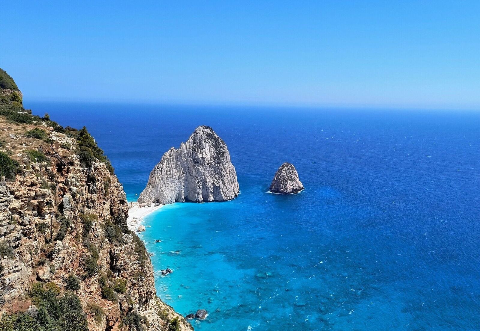 Panoramic cliff view of both Myzithres rock formations with turquoise sea