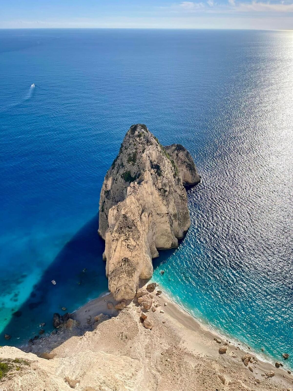 Overhead view of Myzithres rock pillar surrounded by deep blue sea