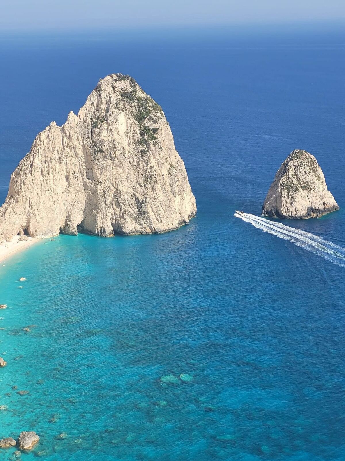 Close-up of Myzithres formation with boat wake trails in the water