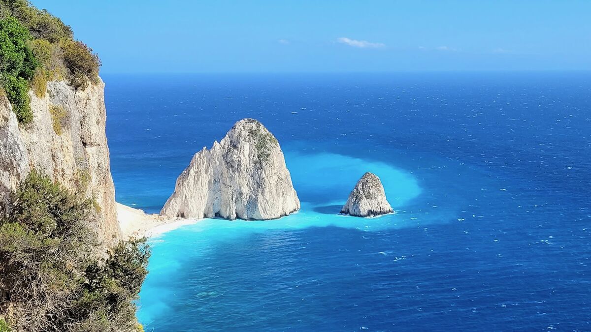 The twin Myzithres rock formations rising from turquoise waters off Zakynthos