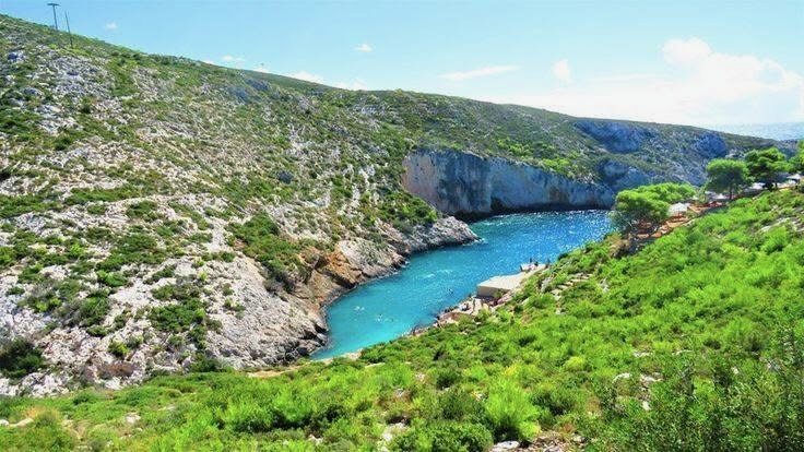 Hilltop view down to the secluded Porto Limnionas cove with the open sea beyond