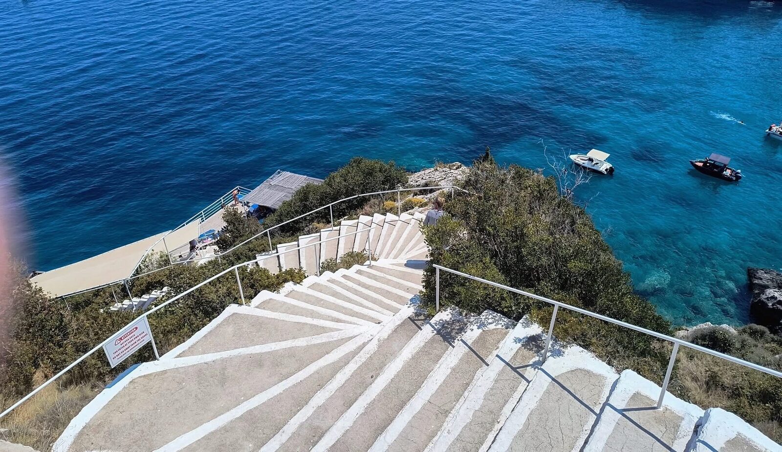 Wide view of the cliffs and turquoise sea at Potamitis Diving Spot