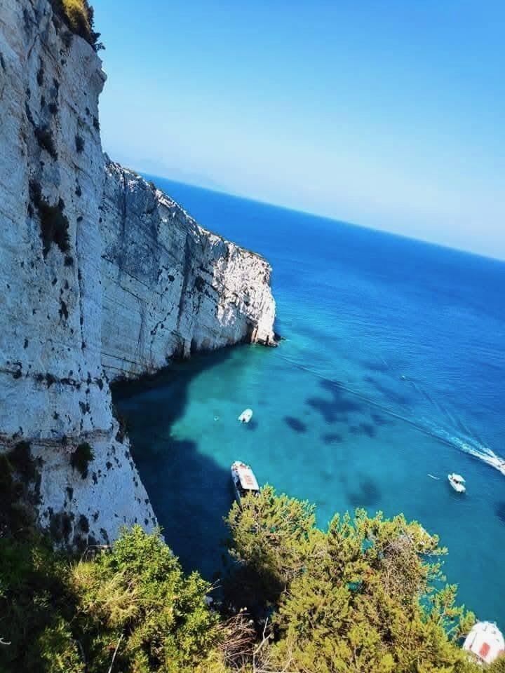 Rocky shoreline and deep blue sea at Potamitis Diving Spot