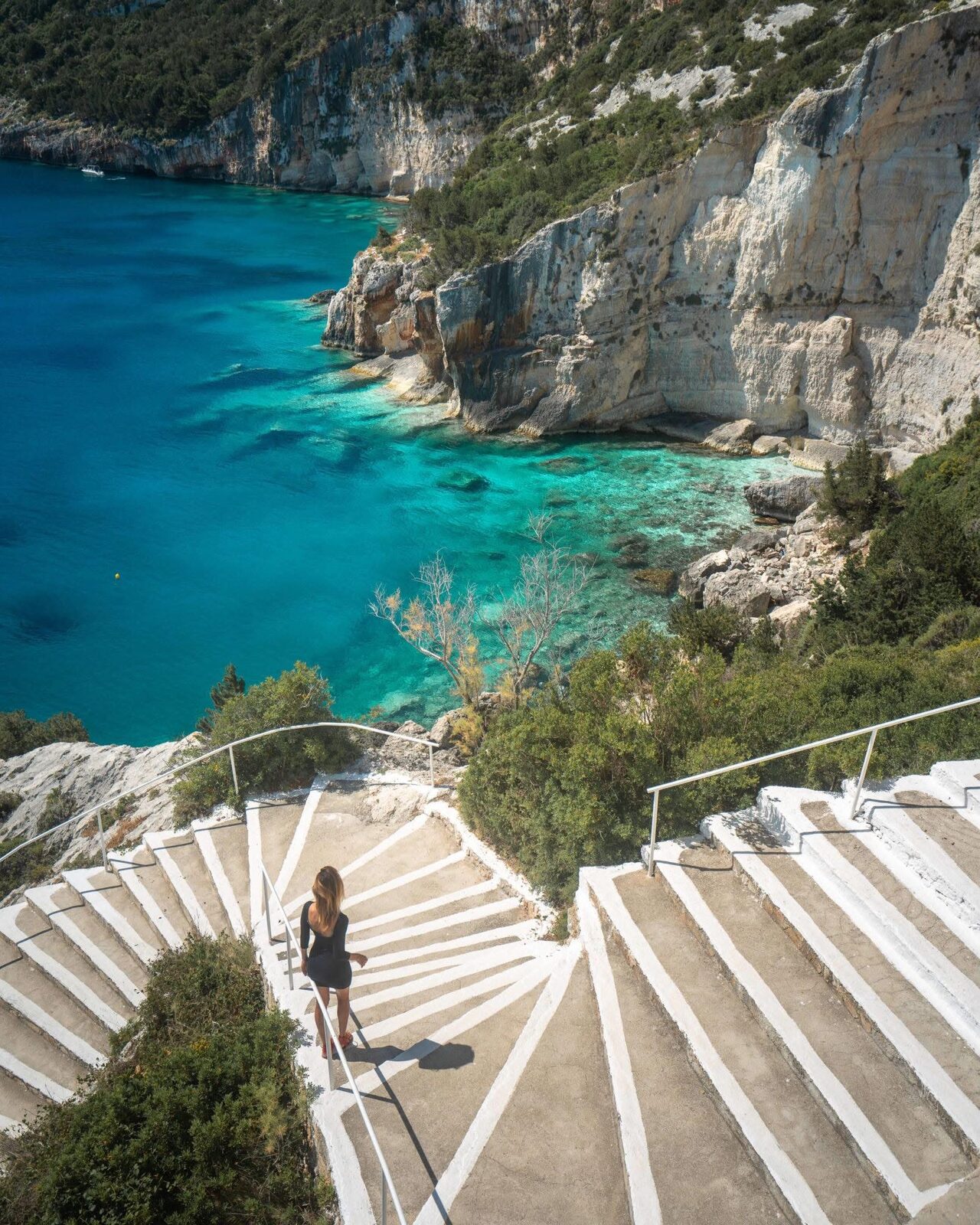 Rocky platform and free sunbeds above the snorkeling cove at Potamitis