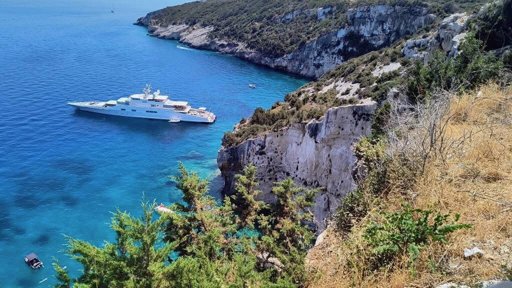Dramatic cliff edge above the deep blue water at Potamitis Diving Spot