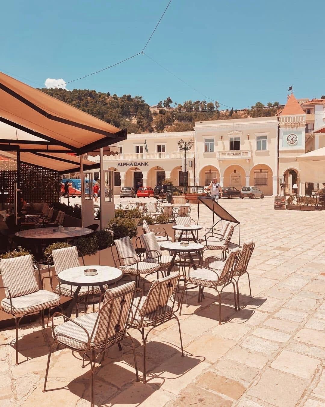 Outdoor café terrace with wicker chairs in the town square